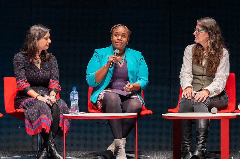 Women discussing PCOS at a conference