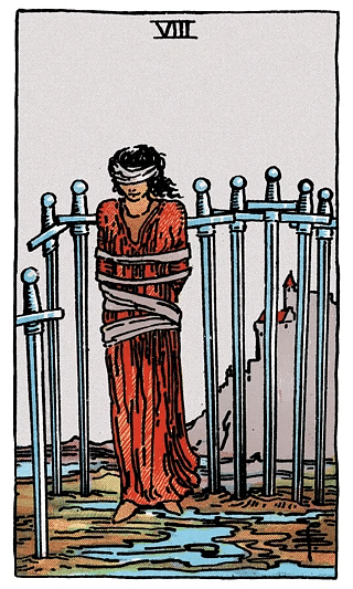 8 of Swords tarot card from the Rider–Waite deck, showing a blindfolded figure bound and surrounded by eight swords in a muddy field
